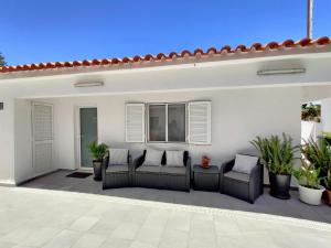 a patio with two chairs and a window at Casa Sequeira in Albufeira