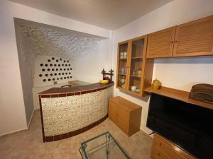 a kitchen with a bar in the middle of a room at Cortijo casa rural "La cueva " in Almería