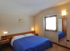 Postel nebo postele na pokoji v ubytování Hotel Ristorante San Pietro