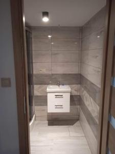 a bathroom with a sink and a shower at Agroturystyka u Chlebków in Ochotnica Górna