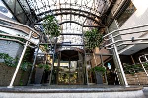 a building with a glass ceiling with plants in it at Master Porto Alegre Hotel - Av Carlos Gomes, Proximo Consulado Americano in Porto Alegre