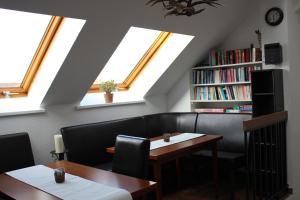 a dining room with skylights and a table and chairs at Haus Witten Höhen in Cuxhaven
