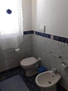 a bathroom with a toilet and a sink at BED & BREAKFAST Villa Cerasa in Case del Bevano