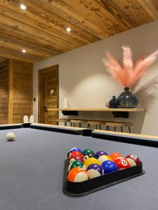 a pool table with balls in a room at Les Mazots des Fées in Morzine