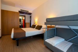 Postel nebo postele na pokoji v ubytování Hotel Cristallo