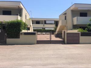 a building with stairs and a fence in front of it at La maison de Medea in Pulsano