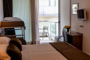 Postel nebo postele na pokoji v ubytování Hotel Cristallo