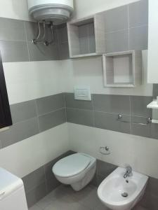 a bathroom with a toilet and a sink at La maison de Medea in Pulsano