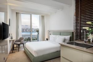 A bed or beds in a room at The G Hotel Seashell