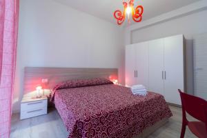 a bedroom with a bed with a red bedspread at Le Casette Di Osvaldo in Lecco