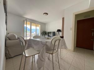 a white table and chairs in a living room at La BELLE VUE in Saint-Claude