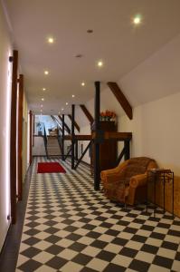 a living room with a checkered floor at Wersauer Hof - Ferme Auberge in Reilingen
