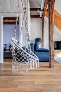 a hanging hammock in a living room at Design Pension Twenty 20 in Poděbrady