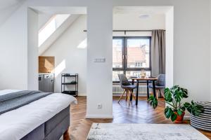 a bedroom with a bed and a table with chairs at Design Pension Twenty 20 in Poděbrady