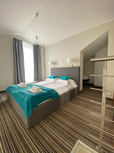 A bed or beds in a room at Apartamenty Krynica No.1