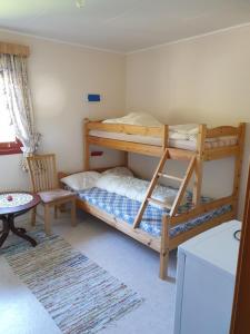 a bedroom with two bunk beds and a table at Rooms for rent in Bø