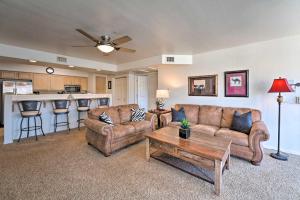 a living room with two couches and a table at Havasu Condo with View of Lake and London Bridge! in Lake Havasu City