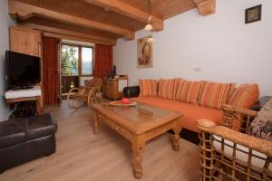 a living room with a couch and a coffee table at Ferienwohnungen Schneider in Kirchdorf in Tirol