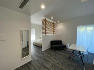 a bedroom with a bed and a table and a chair at Blue Bay Suite & Spa in Agropoli