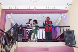 a group of people standing on a balcony at Britannia Hôtel Cmr in Yaoundé