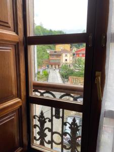 a view from a window of a city street at Hotel Piloñés in Infiesto