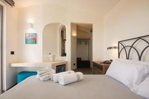 a bedroom with two white towels on a bed at Insula Boutique Hotel in Procida +37 photos