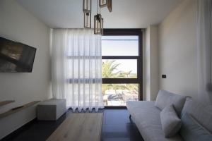 a living room with a couch and a large window at Villa Irina sea view in Sykia Chalkidikis