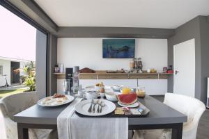 a dining room with a table with food on it at Villa Irina sea view in Sykia Chalkidikis