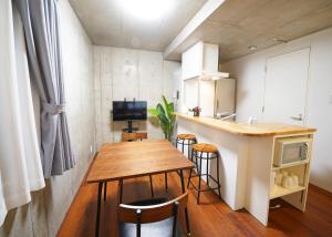 a small kitchen with a wooden table and a counter at ラフィット御徒町 in Tokyo