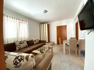 a living room with a couch and a table at Apartments Popović in Budva