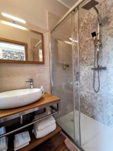 a bathroom with a sink and a shower at La Luna dei Medici in Fivizzano