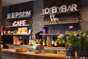a bar with a lot of glasses on the shelf at Hordatun Apartments in Røldal