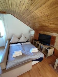 a bedroom with a bed with a wooden ceiling at Studio Apartment in Bermatingen