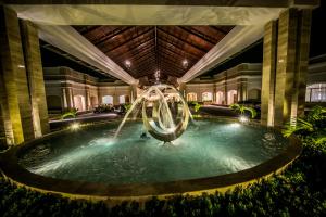 a statue of a man in a swimming pool at Majestic Mirage Punta Cana, All Suites – All Inclusive in Punta Cana