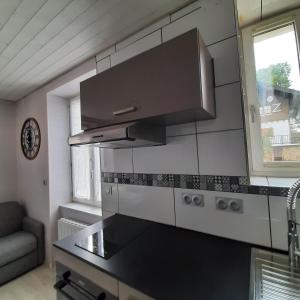 a kitchen with a black counter top in a room at Chez Louis - Studio Rénové proche Hyper Centre - Résidence La Fresnaie in Les Rousses