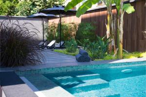 a swimming pool in a yard with an umbrella at Trend Suites CYCLE in Antalya