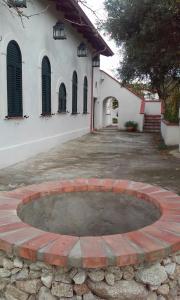 a brick circle in front of a building at dastemi in Parghelia