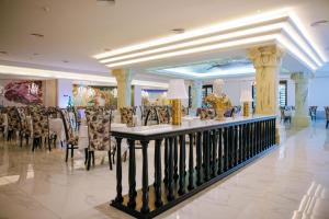 a restaurant with a table and chairs in a lobby at Majestic Mirage Punta Cana, All Suites – All Inclusive in Punta Cana