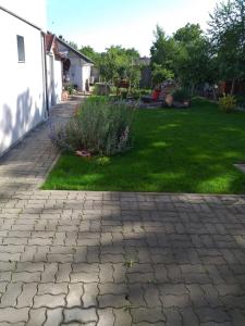 a yard with a brick walkway and a yard with grass at Joy Residence in Timişoara
