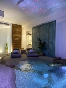 a room with a swimming pool in the middle of the room at Blue Bay Suite & Spa in Agropoli
