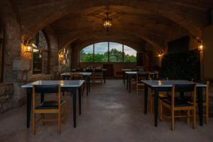 a restaurant with tables and chairs and a large window at Santuari de la Mare de Déu de la Salut de Terrades in Terrades