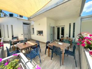 a patio with tables and chairs on a deck at VILLA MARIS in Agropoli