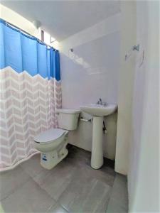 a bathroom with a toilet and a sink at Hotel Costa Maria in Ciudad del Carmen