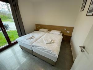 A bed or beds in a room at Resort Nová Pec