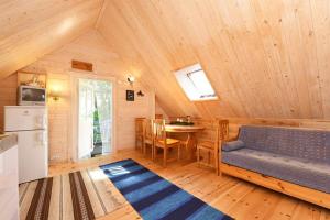 a room with a couch and a table in a cabin at Judbidzi in Pape +56 photos
