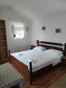 a bedroom with a large bed with white sheets at House Valun 42 in Valun
