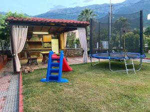 a playground with a table and a trampoline at Studios Anna Paradise in Skala Potamias