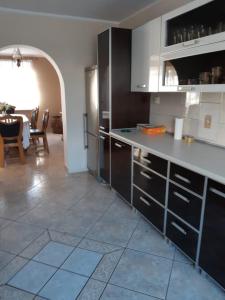 a kitchen with black cabinets and a tile floor at Willa Ola in Nadole