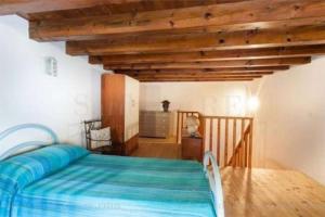 a bedroom with a bed and a wooden table at House by the sea in Gonnesa