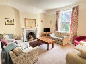 a living room with couches and a fireplace at Croxton House in Kirmington